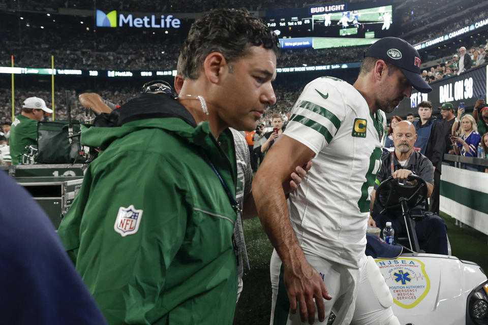 New York Jets quarterback Aaron Rodgers (8) is helped off the field during the first quarter against the Buffalo Bills, on Monday, Sept. 11, 2023, in East Rutherford, N.J. (AP Photo/Adam Hunger)