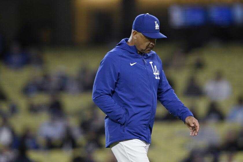 Los Angeles Dodgers manager Dave Roberts walks back to the dugout after making a pitching change.